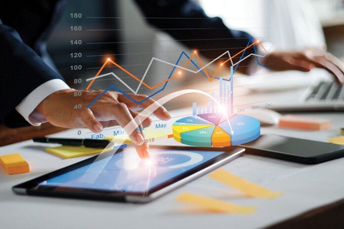 Businessman using tablet and laptop analyzing sales data and economic growth graph chart. Business strategy. Digital marketing. Business innovation technology concept Businessman using tablet and laptop analyzing sales data and economic growth graph chart. Business strategy. Digital marketing. Business innovation technology concept