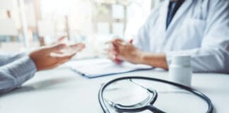 Doctors and patients consulting and diagnostic examining sit and talk. At the table near the window in the hospital medicine concept
