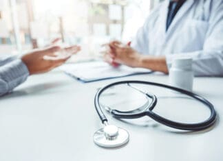 Doctors and patients consulting and diagnostic examining sit and talk. At the table near the window in the hospital medicine concept