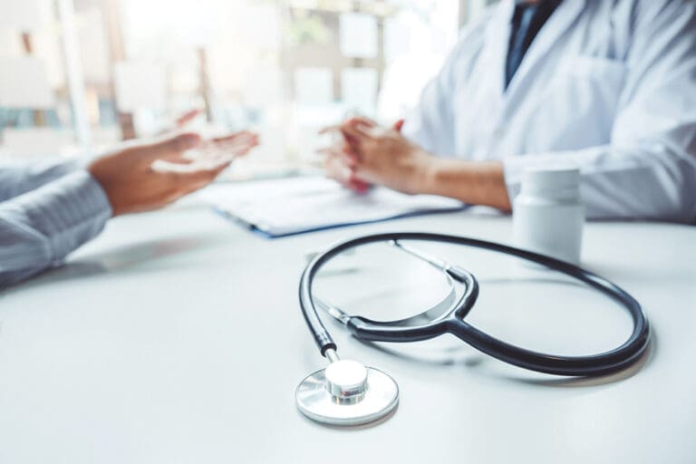 Doctors and patients consulting and diagnostic examining sit and talk. At the table near the window in the hospital medicine concept