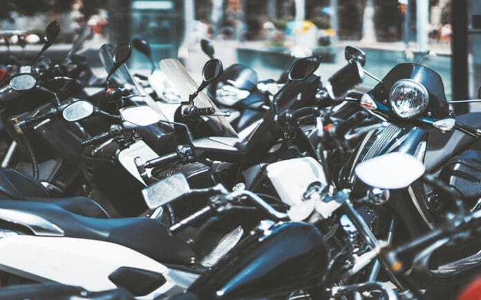 Plenty of motorcycles parked outdoors