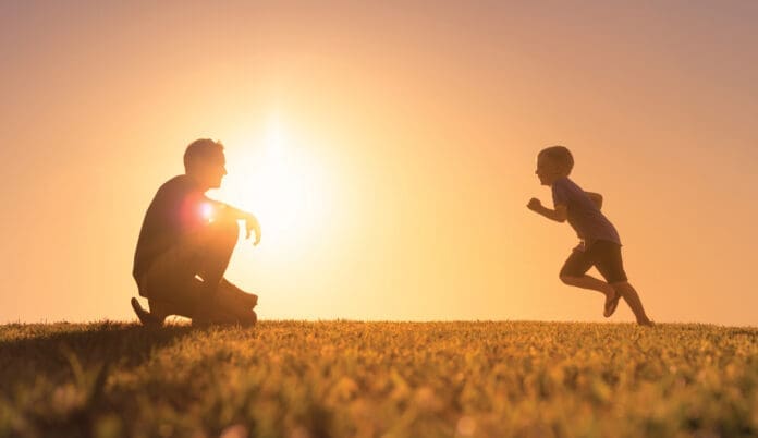 Father playing with his son in the park.