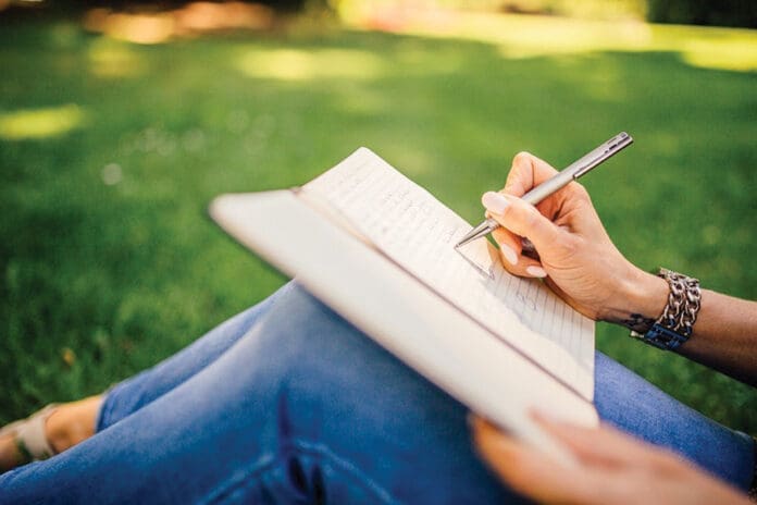 Free close up of a hand writing notes in a journal photo, public
