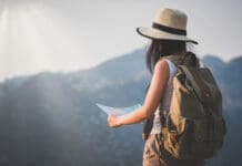 activity young woman watching binoculars in nature park , Tourist traveler backpack Happy and freedom with copy space ,travel concept.
