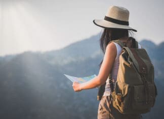 activity young woman watching binoculars in nature park , Tourist traveler backpack Happy and freedom with copy space ,travel concept.