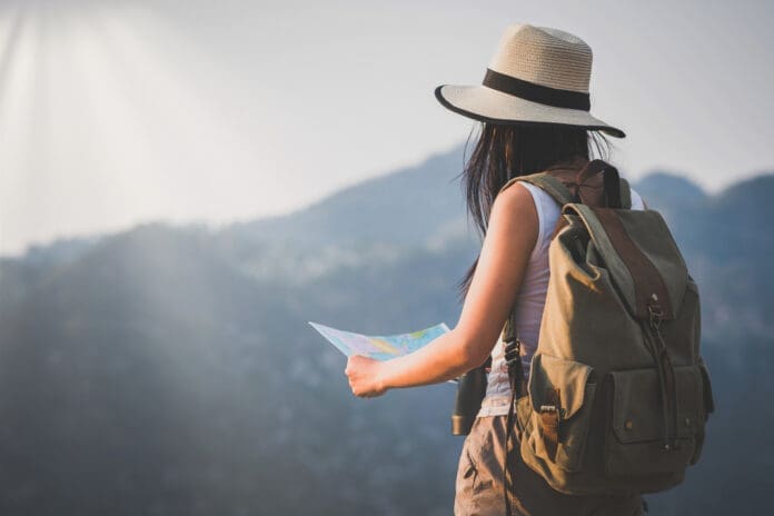 activity young woman watching binoculars in nature park , Tourist traveler backpack Happy and freedom with copy space ,travel concept. activity young woman watching binoculars in nature park , Tourist traveler backpack Happy and freedom with copy space ,travel concept.