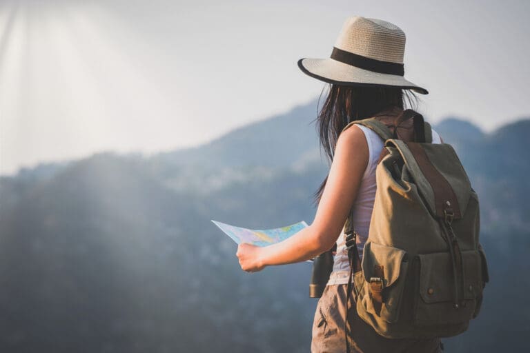 activity young woman watching binoculars in nature park , Tourist traveler backpack Happy and freedom with copy space ,travel concept.