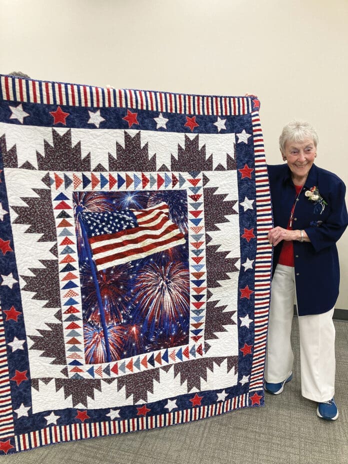 Constance Newhouse being awarded The Quilt of Valor