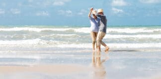Senior couple dancing on beach
