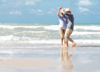 Senior couple dancing on beach