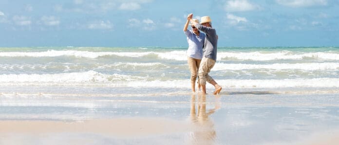 Senior couple dancing on beach