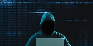 Big financial data theft concept. An anonymous hacker is hacking highly-protected financial data through computers.