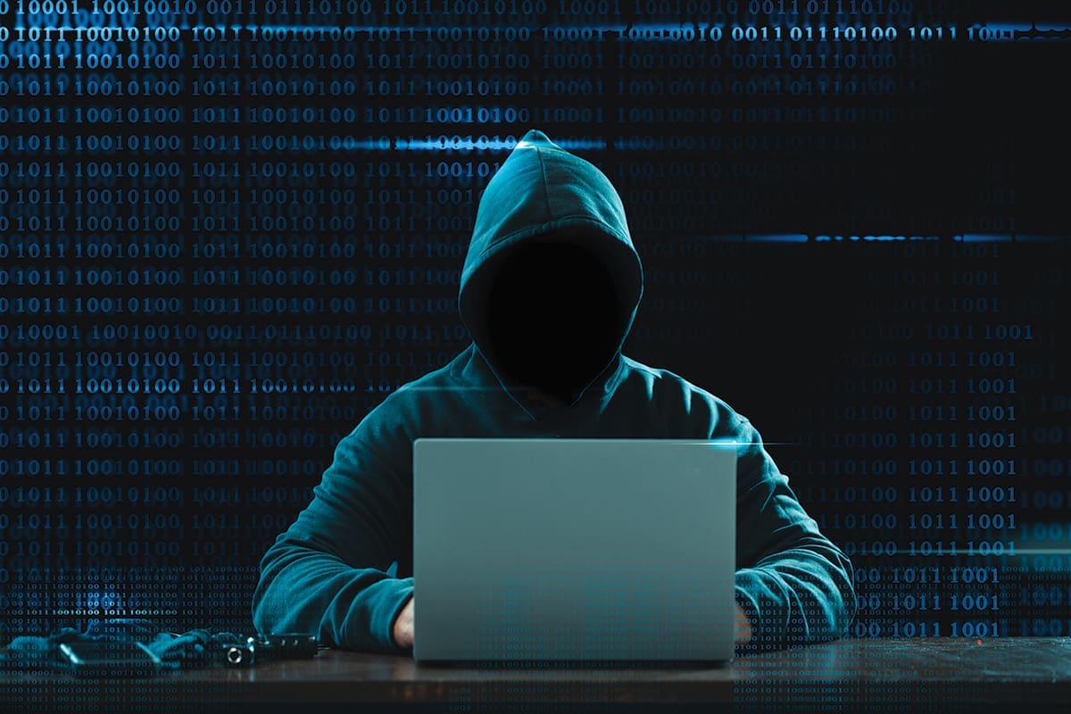Big financial data theft concept. An anonymous hacker is hacking highly-protected financial data through computers.
