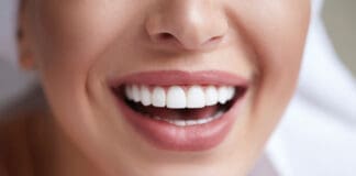 Healthy white smile close up. Beauty woman with perfect smile, lips and teeth. Beautiful Model Girl with perfect skin. Teeth whitening.