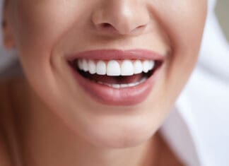 Healthy white smile close up. Beauty woman with perfect smile, lips and teeth. Beautiful Model Girl with perfect skin. Teeth whitening.