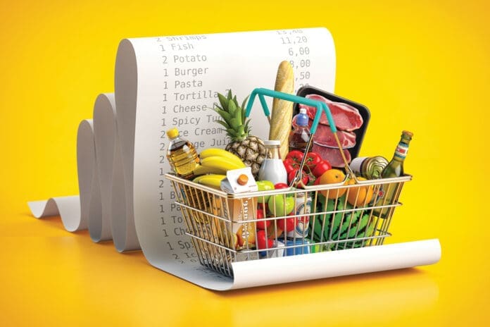 Shopping basket with foods on receipt. Grocery expenses budget, inflation and consumerism concept.