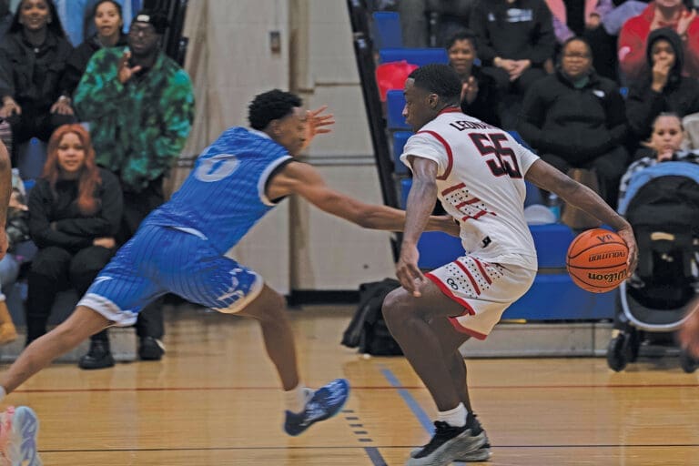 A member of the Eglin Eagles basketball team attempts to steal a ball from a member of the Hurlburt Field Air Commandos, at Hurlburt Field, Florida, Jan. 10, 2025. The game, known as the Emerald Coast Rivalry, brought both base communities together to watch their teams compete. (U.S. Air Force photo by Airman 1st Class Samantha Rossi)