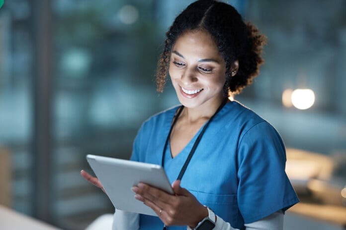 Nurse, medical tablet and black woman in hospital working late on telehealth, research or online consultation. Tech, healthcare or female physician with technology for wellness app in clinic at night