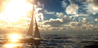 Beautiful Sunset At The Ocean With Sailboat Background.