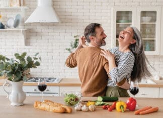 Happy Couple in Kitchen iStock 1328351784