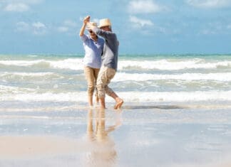 The 5 Keys to Longevity Seniors dancing on beach iStock 1322107306 696x409