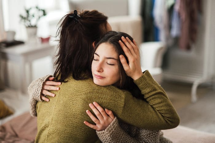 Teenager Hugging Parent iStock-1476266423 Teenager Hugging Parent iStock 1476266423